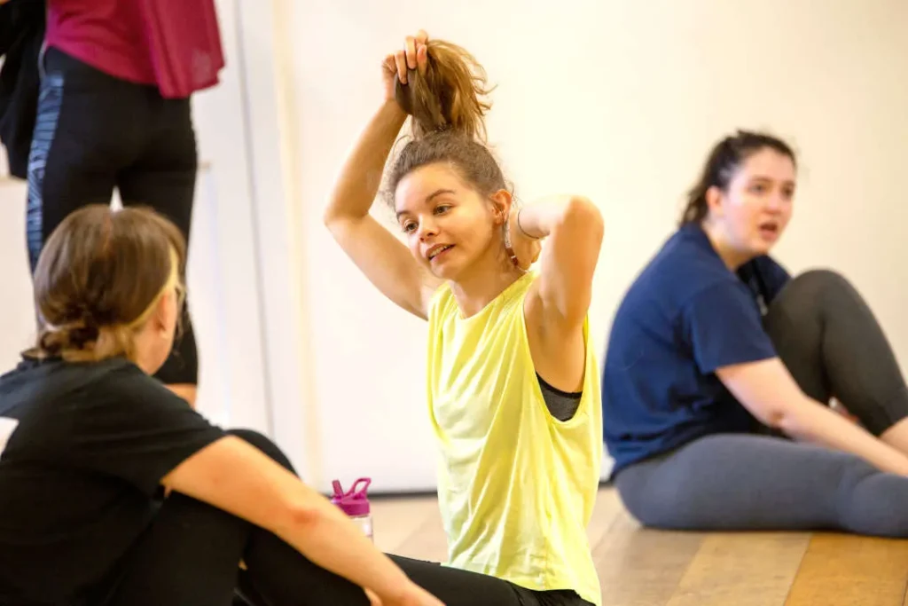 Home 6 Adult dancers chatting on the studio floor between exercises at Hype Dance's Sheffield studio