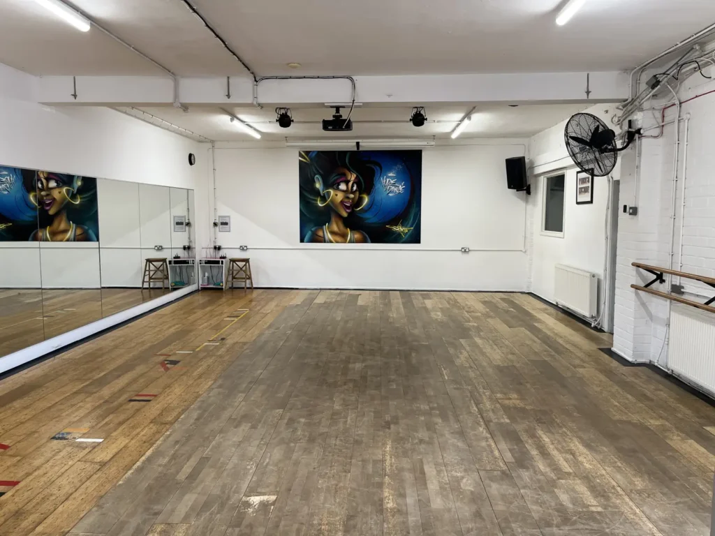 Home 11 Dance studio 2 at Hype Dance in Sheffield, with a wall of mirrors, a mural on the end wall and ballet barres